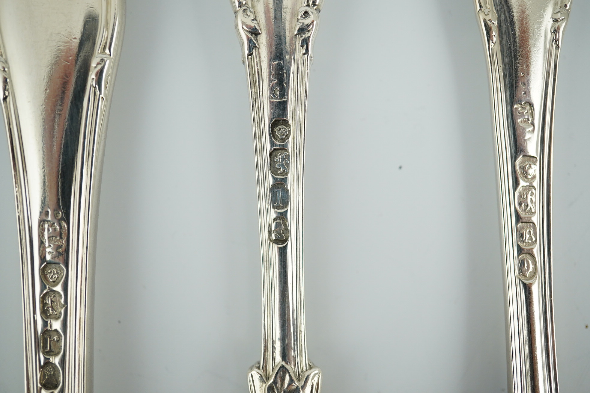 A matched part canteen of George IV and later silver shell scroll pattern flatware